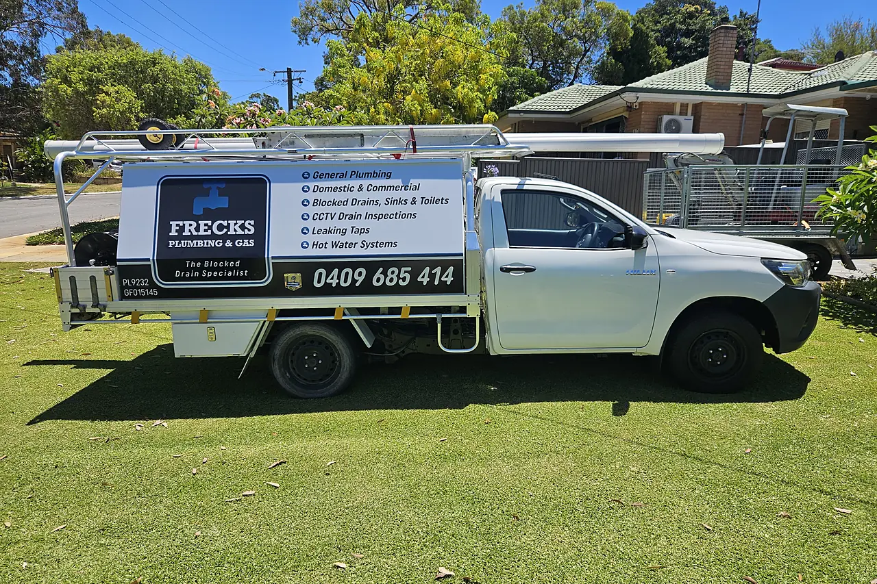 Frecks Plumbing & Gas branded ute parked outside a home in Perth's southern suburbs