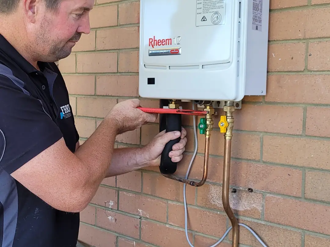 Frecks Plumbing & Gas servicing a gas continuous-flow hot water unit in Perth's southern suburbs