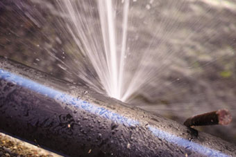 Burst water pipe leaking water